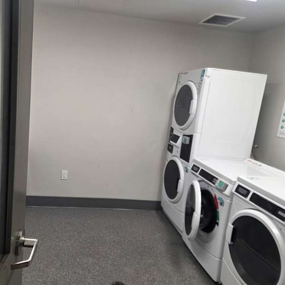a laundromat with a row of washers and dryers.